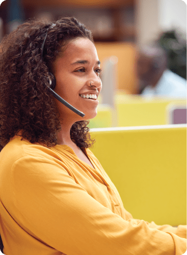 Happy woman working in a call centre.